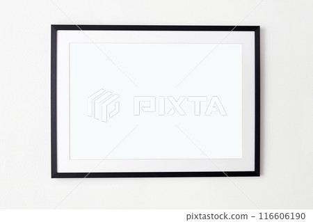 big black picture frame on white wall. Stylish photoframe with passe-partout big black picture frame on white wall. Stylish photoframe with passe-partout 116606190