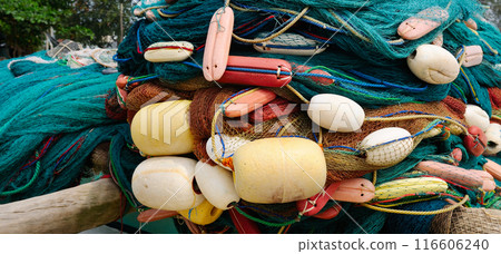 Fishing gear, nets, and floats are dried on the shore. Fishing gear, nets, and floats are dried on the shore. 116606240