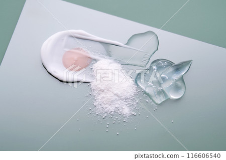 Textures of different cosmetic products on a green background. 116606540