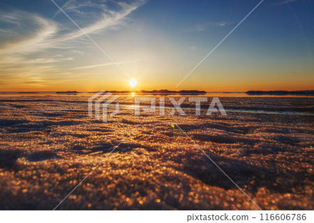 Beautiful winter sunset by the sea with iceberg Beautiful winter sunset by the sea with iceberg 116606786