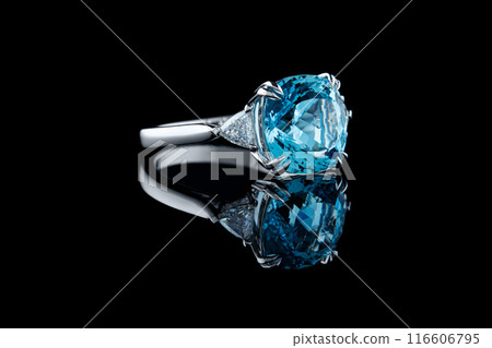 Beautiful gold ring with aquamarine and diamonds on a black background 116606795