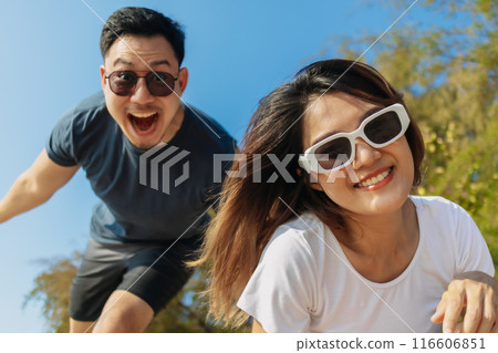 Cheerful and playful couple lover is taking selfie photo with bright sky. Cheerful and playful couple lover is taking selfie photo with bright sky. 116606851