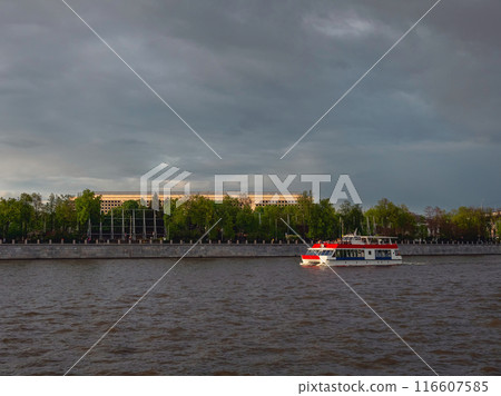 Dramatic view of the Moskva River. A red tourist launch at sunse Dramatic view of the Moskva River. A red tourist launch at sunse 116607585