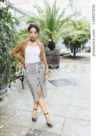 Stylish Young Woman in Modern Outfit Posing in an Urban Botanical Garden Stylish Young Woman in Modern Outfit Posing in an Urban Botanical Garden 116607856