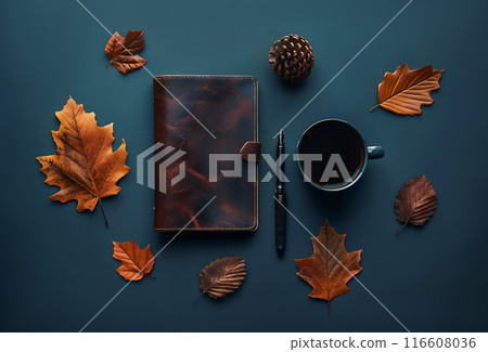Masculine workspace flat lay with autumn leaves, brown leather notebook, pen, and coffee cup on aqua blue background. Great design with copy space. 116608036