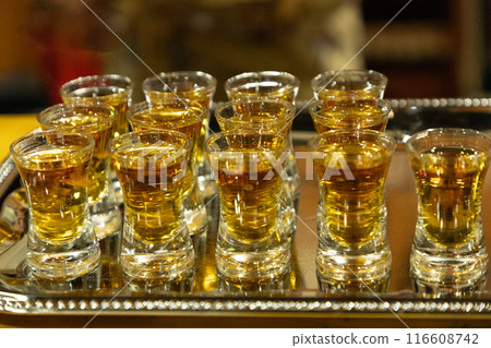 Strong alcoholic drink in small glasses. Strong alcoholic drink in small glasses. 116608742