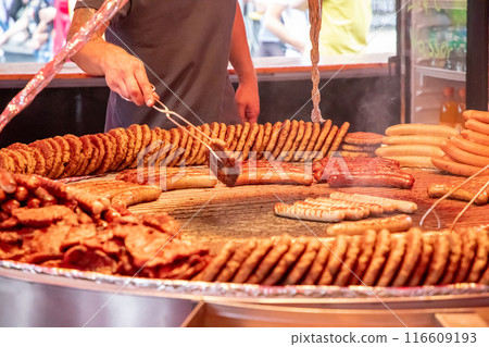 large grill filled with various types of german sausages 116609193