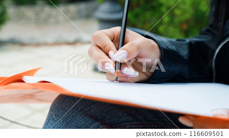 writing on the paper with pencil writing on the paper with pencil 116609501