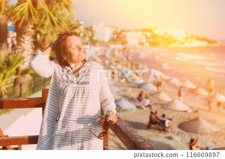Adult Caucasian Woman Relaxed Posing On Sunset Beach. Vacation On Sea Ocean Beach 116609897