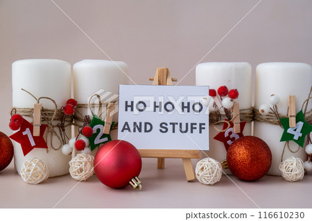 Message on greeting card HO HO HO AND STUFF text on paper note Traditional four advent weeks calendar before Christmas holidays. Candles and plastic free zero waste sustainable decoration. Greeting 116610230