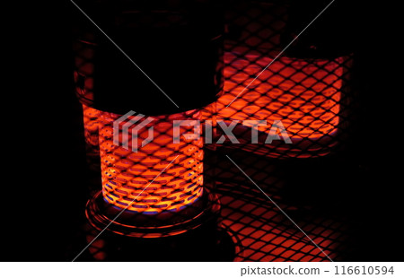 The glowing heat source of a reflective oil stove 116610594