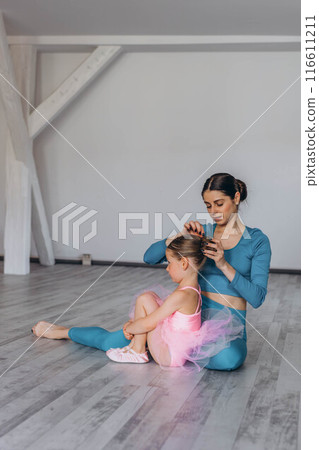 Baby ballet studio. Little ballerina with a coach in dance class. Ballet trainer for children 116611211