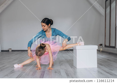 Baby ballet studio. Little ballerina with a coach in dance class. Ballet trainer for children 116611214