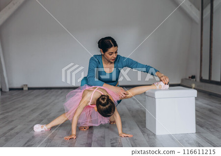 Baby ballet studio. Little ballerina with a coach in dance class. Ballet trainer for children Baby ballet studio. Little ballerina with a coach in dance class. Ballet trainer for children 116611215