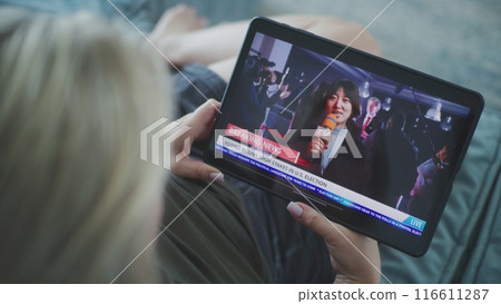 Tablet screen shows playback of news broadcast report about US election Tablet screen shows playback of news broadcast report about US election 116611287
