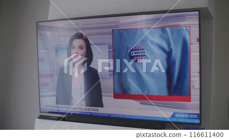 Adult woman watches TV news about elections in USA 116611400