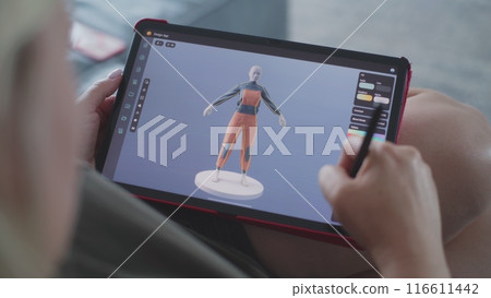 Woman creates 3D model using tablet computer and digital pen 116611442
