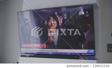 Asian news anchor reports breaking news live on Election Day 116611530