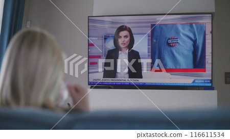 Adult woman watches TV news about elections in USA 116611534