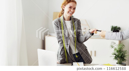 Customer Shopping Designer Wear At Fashion Boutique, Making Payment WIth Credit Card Customer Shopping Designer Wear At Fashion Boutique, Making Payment WIth Credit Card 116612588