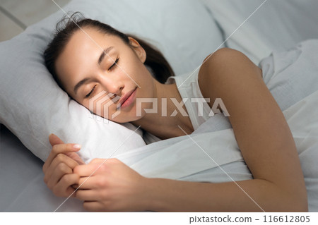 Rest Reinstatement For Active Life. Woman Sleeping In Bed In The Morning Rest Reinstatement For Active Life. Woman Sleeping In Bed In The Morning 116612805