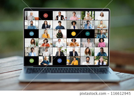 A laptop screen showing a group of individuals engaged in a virtual meeting or video conference. The people on the screen appear to be conversing or collaborating on a project remotely. 116612945