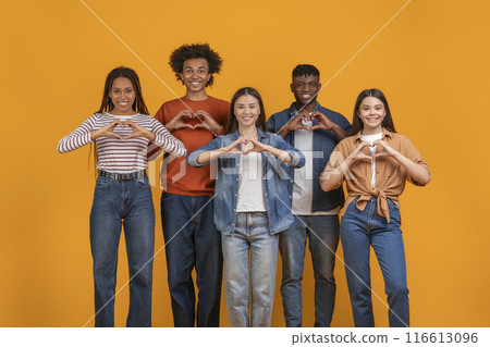 This photo features five diverse young adults making heart shapes with their hands. They are standing in a row in front of a bright yellow background This photo features five diverse young adults making heart shapes with their hands. They are standing in a row in front of a bright yellow background 116613096