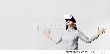 Excited Businesswoman Experiencing Virtual Reality Wearing VR Headset On White Background In Studio. Panorama 116613116