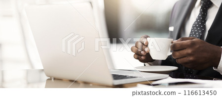 Afro Business Man Drinking Coffee At Laptop In Outdoor Cafe In City Center. Closeup, Selective Focus 116613450