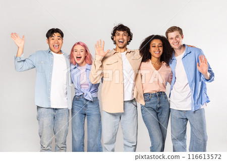 A group of five young adults, representing diverse ethnicities and genders, stand together against a white background. They are all smiling and appear to be happy and friendly. A group of five young adults, representing diverse ethnicities and genders, stand together against a white background. They are all smiling and appear to be happy and friendly. 116613572