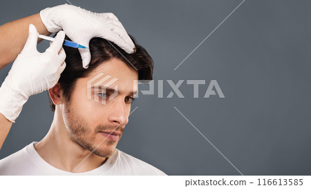 Man with hair loss problem receiving injection in head, grey background, empty space 116613585