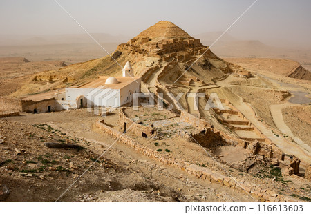 Deserted village of Ksar Guermessa with white mosque in Tunisia Deserted village of Ksar Guermessa with white mosque in Tunisia 116613603