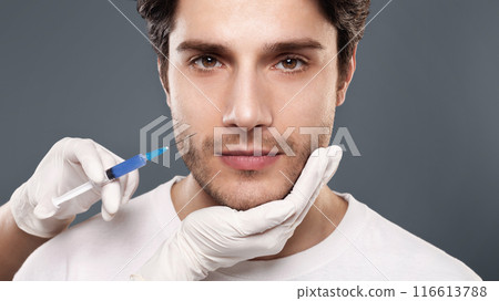 Plastic surgery concept. Man receiving injection in his face. Trendy cosmetics procedure for men 116613788
