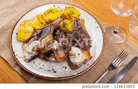 Steak served with potatoes on platter 116613803