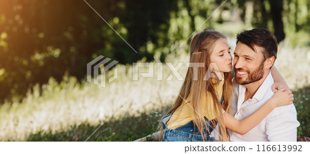 Lovely family on picnic. Daugher kissing father on cheek, resting in nature 116613992
