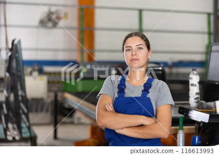 Confident smiling young female worker in glass workshop 116613993