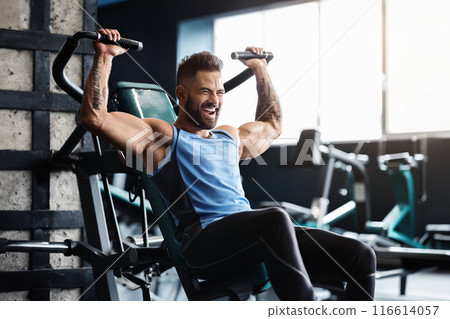 Chest exercise. Handsome muscular man working out hard at gym, free space Chest exercise. Handsome muscular man working out hard at gym, free space 116614057