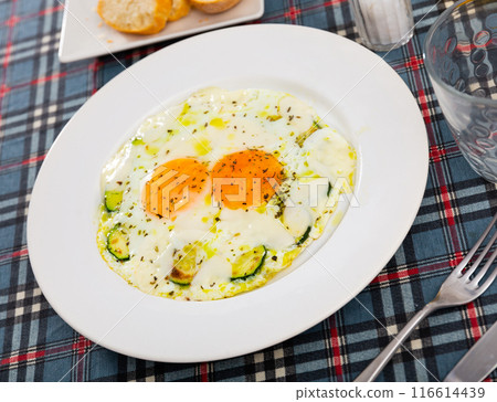 Homemade hearty breakfast - fried eggs with zucchini 116614439