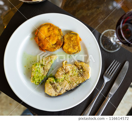 Fried swordfish fillet served with eggplant 116614572