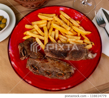 Churrasco de ternera, grilled veal spare ribs with garnish of french fries Churrasco de ternera, grilled veal spare ribs with garnish of french fries 116614779