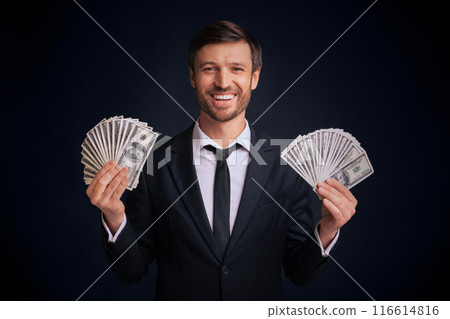 Profit. Happy Businessman Holding Money Cash In Both Hands Standing Over Black Background In Studio. 116614816