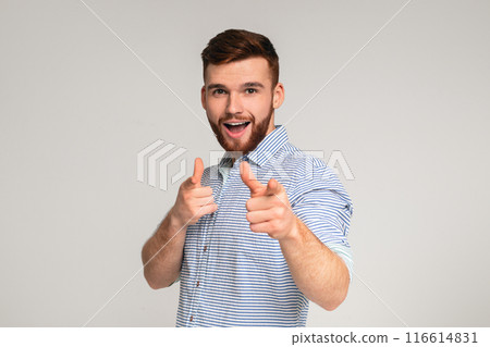 You are cool. Young redhaired man gesturing on studio background, pointing at camera with both hands, copy space 116614831