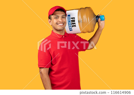 A cheerful delivery worker in a red uniform and cap is holding a large water jug on his shoulder. The worker appears friendly and approachable against a vibrant yellow background. A cheerful delivery worker in a red uniform and cap is holding a large water jug on his shoulder. The worker appears friendly and approachable against a vibrant yellow background. 116614906