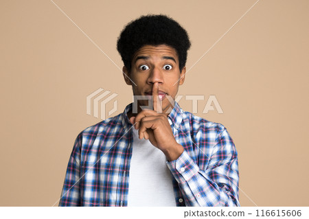 Just don't speak. Teen making hush gesture over light background Just don't speak. Teen making hush gesture over light background 116615606
