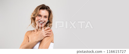 Natural Beauty. Portrait Of Attractive Middle Aged Woman Wrapped In Bath Towel Smiling At Camera, Happy Beautiful Good Looking Lady Enjoying Selfcare, Posing Over Light Studio Background, Copy Space 116615727