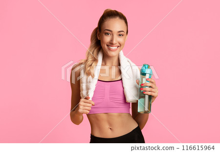 Hydration. Fitness Girl Holding Water Bottle And Towel Posing On Yellow Studio Background. Empty Space 116615964