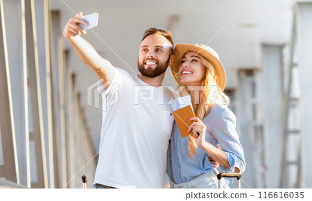 We love traveling. Loving couple making selfie, waiting for boarding in airport, free space 116616035