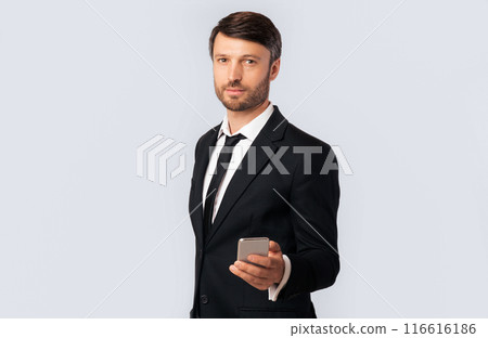Call Me Concept. Businessman Holding Mobile Phone Standing Over White Studio Background. Empty Space, Isolated 116616186