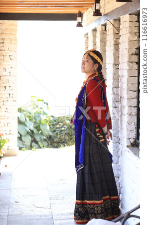 a girl with Gurung traditional dressing a Gurung village in Ghandruk town, Gandaki Province of Nepal, is a point of Annapurna circuit trek and Poonhill trekking in Nepal  116616973