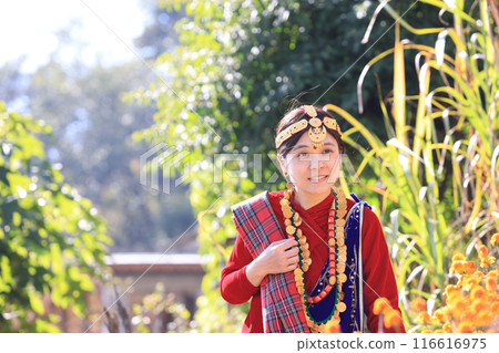 a girl with Gurung traditional dressing a Gurung village in Ghandruk town, Gandaki Province of Nepal, is a point of Annapurna circuit trek and Poonhill trekking in Nepal  116616975
